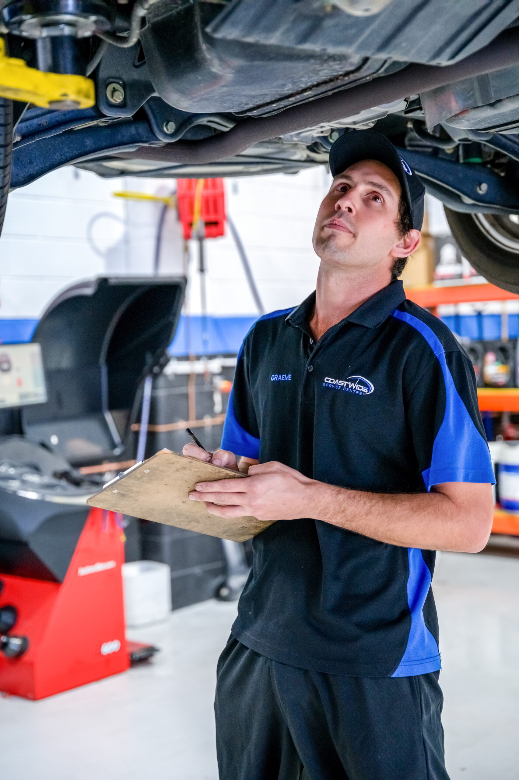 Coastwide Service Centre car mechanic evaluating the car's condition for roadworthy certificate qld and logbook service